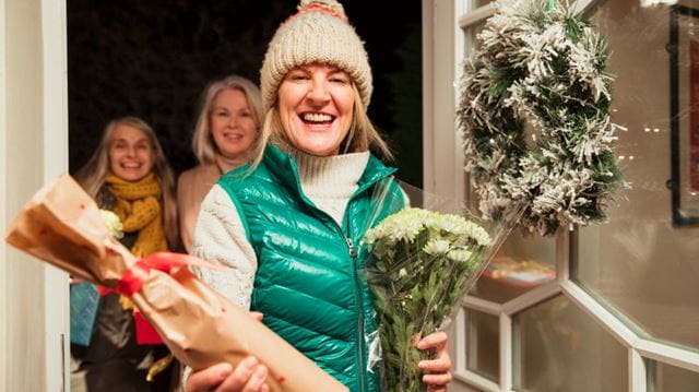 group of women arrive at house with gifts